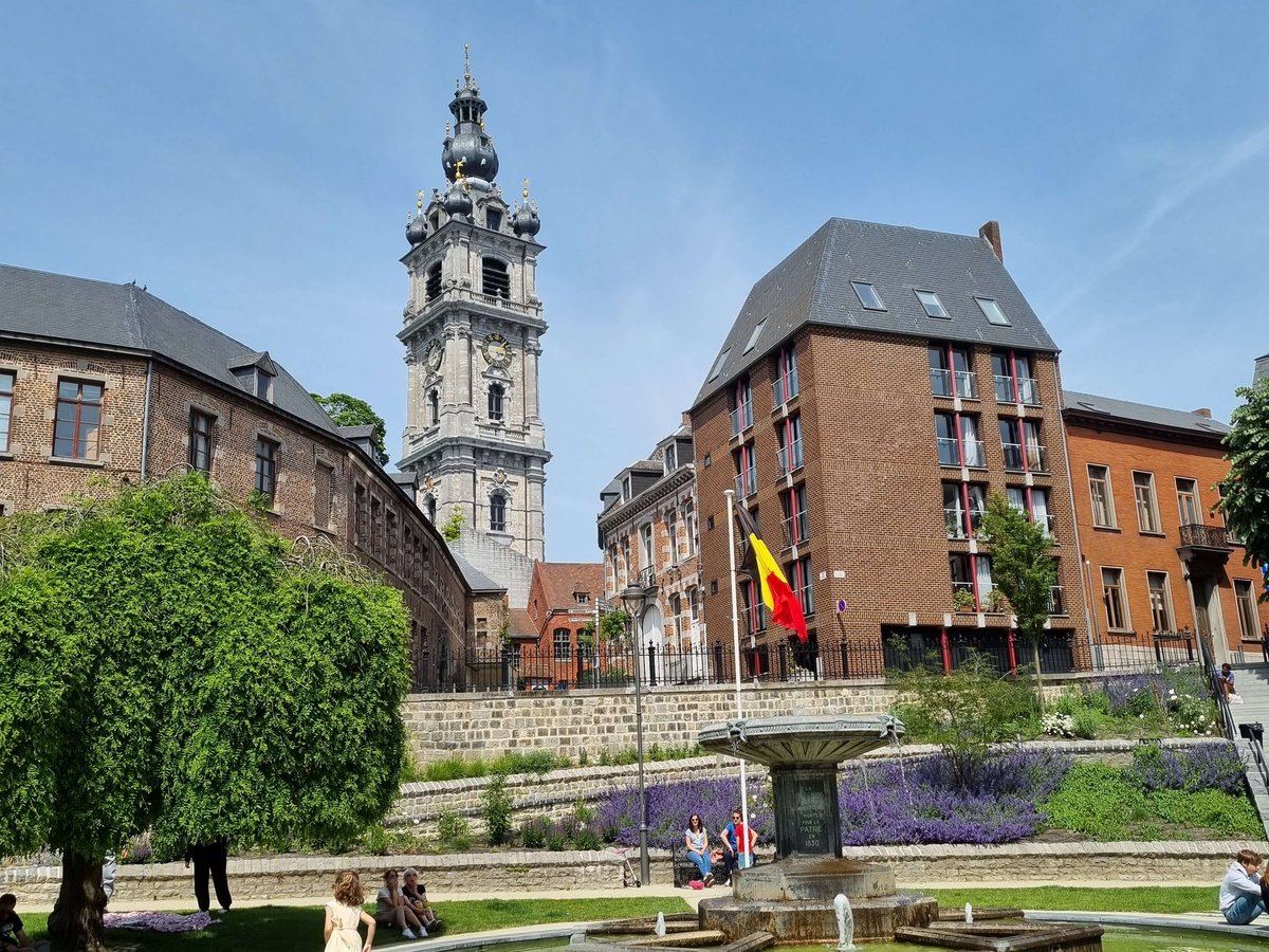 Le beffroi baroque de Mons au-dessus d’un jardin public et de sa fontaine